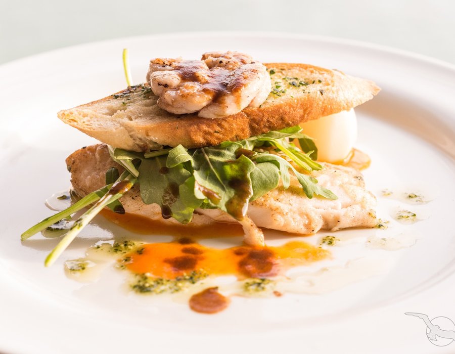 schmackhaft zubereitetes Hähnchenbrustfilet zwischen zwei Scheiben frischen Kreuterbaguette